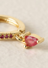 Gold hoop earrings with red crystal detail