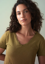 Woman wearing a olive green v-neck cotton t-shirt