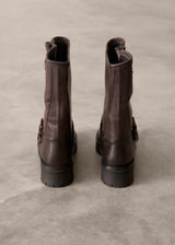 Pair of brown leather boots on a textured gray surface