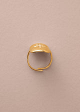 Gold ring on a beige background