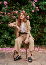 Woman wearing beige blazer with matching beige wide leg trousers