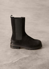 Black Chelsea boot on a gray textured background