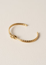 Gold bracelet on a beige background