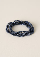 Blue beaded bracelet on a beige background