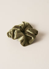 Green scrunchie on a beige background