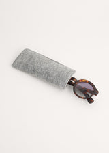 Oversized circular sunglasses with tortoiseshell pattern and blue lenses