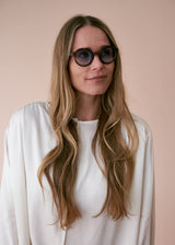 Oversized circular sunglasses with tortoiseshell pattern and blue lenses