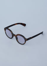 Oversized circular sunglasses with tortoiseshell pattern and blue lenses