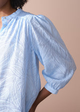Light blue textured lacey blouse with puff sleeves