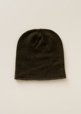 A dark olive green ribbed knit beanie hat, photographed flat against a light beige background.