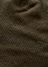 Close-up of a dark brown ribbed knit fabric texture with soft folds and shadows.