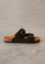 Black sandal with cork sole on a gray background