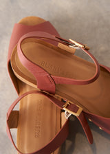 Close-up of a sandal with visible brand name on a neutral background