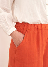 Red cropped linen trousers