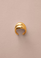 Gold ring on a beige background