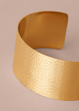 Gold bracelet on a beige background