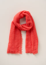 Coral pink scarf on a light beige background
