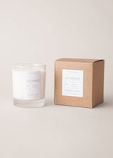 Alchemist candle with a scents of neroli, lavender and rosemary, beside a gift box, on a beige background