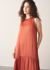 Woman wearing terracotta satin sleeveless midi dress