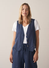 Woman wearing a navy blue linen waistcoat with wide leg linen trousers