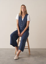 Woman wearing a navy blue linen waistcoat with wide leg linen trousers