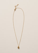 Gold minimal necklace with a simple oval pendant on a beige background