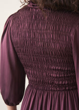 Woman wearing plum satin dress