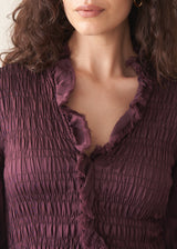 Woman wearing plum satin dress