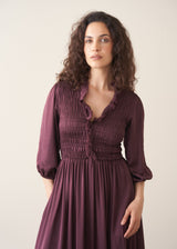 Woman wearing plum satin dress
