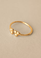 Gold open centre adjustable bubble ring won beige background