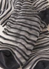 Close up of black and sheer striped cotton blend ankle socks with ribbed hem