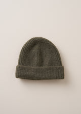 A super soft, alpaca wool blend beanie in khaki, on a beige background