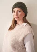 Women wearing a super soft, alpaca wool blend beanie in khaki, styled with an oatmeal sweater