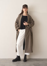 Woman wearing black relaxed sleeve sweater and white barrel leg jeans