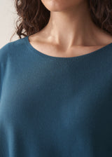 Woman wearing bright blue sleeveless knitted sweater