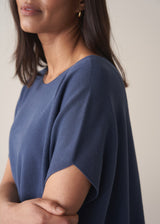 Woman wearing a navy blue sleeveless sweater