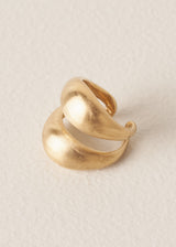 Bold, eye-catching ring with a chunky double-band design and brushed gold finish, on a beige background