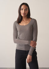 Woman wearing cashmere-blend long sleeve stripe top and black wide leg cropped trousers.