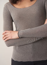 Woman wearing cashmere-blend long sleeve stripe top and black wide leg cropped trousers.