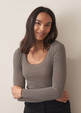 Woman wearing cashmere-blend long sleeve stripe top and black wide leg cropped trousers.