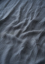 Close up of material on dusky blue cashmere blend scarf