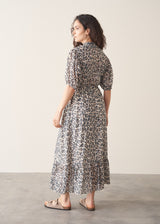 Woman wearing grey leopard print dress and nude sandals