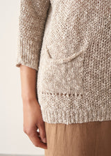 Close up of pocket detail on a beige lightweight knitted sweater