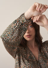 Woman wearing a leopard print wrap dress