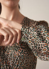 Woman wearing a leopard print wrap dress