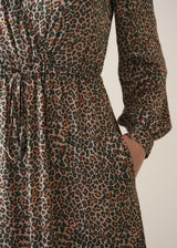 Woman wearing a leopard print wrap dress