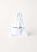 A white fabric drawstring jewellery bag on a white background