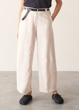 Woman wearing grey v-neck t-shirt and off white barrel leg trousers