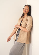 Woman wearing beige blazer with stripe trousers and a black top