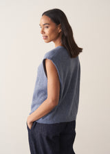 Woman wearing a blue sleeveless knitted waistcoat